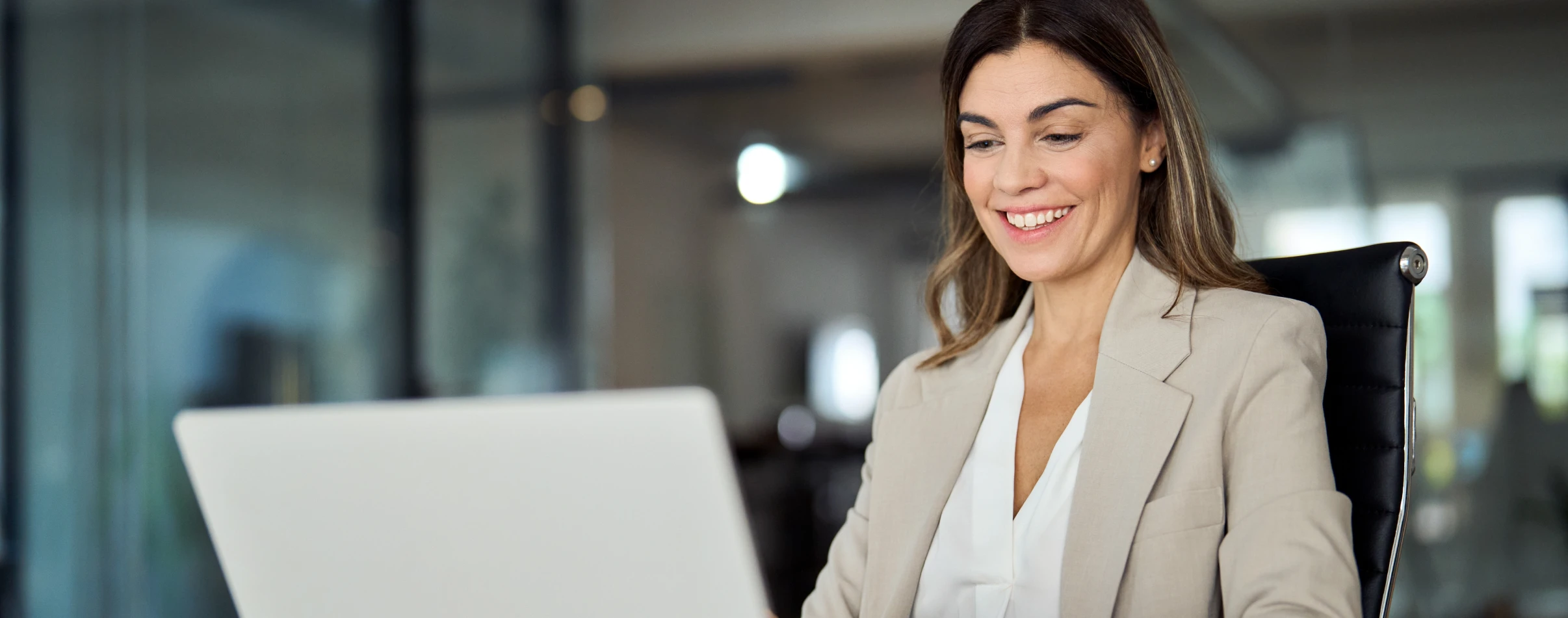 Administrator smiling while on computer.