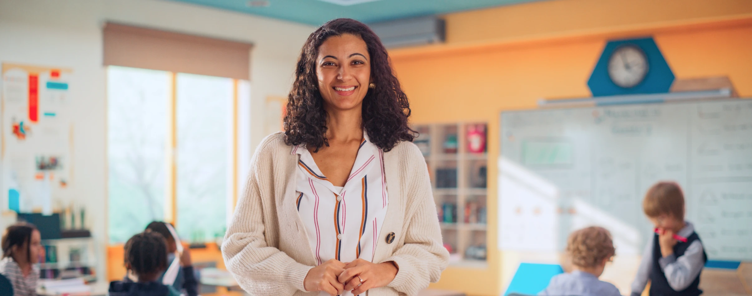 School administrator smiling in a classroom environment