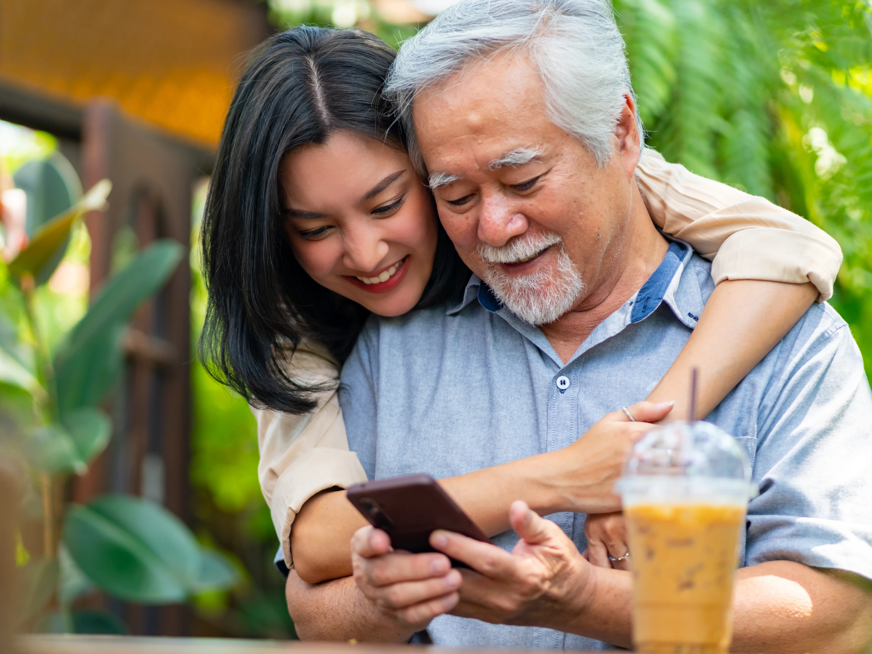 Man and woman look at a mobile device together.