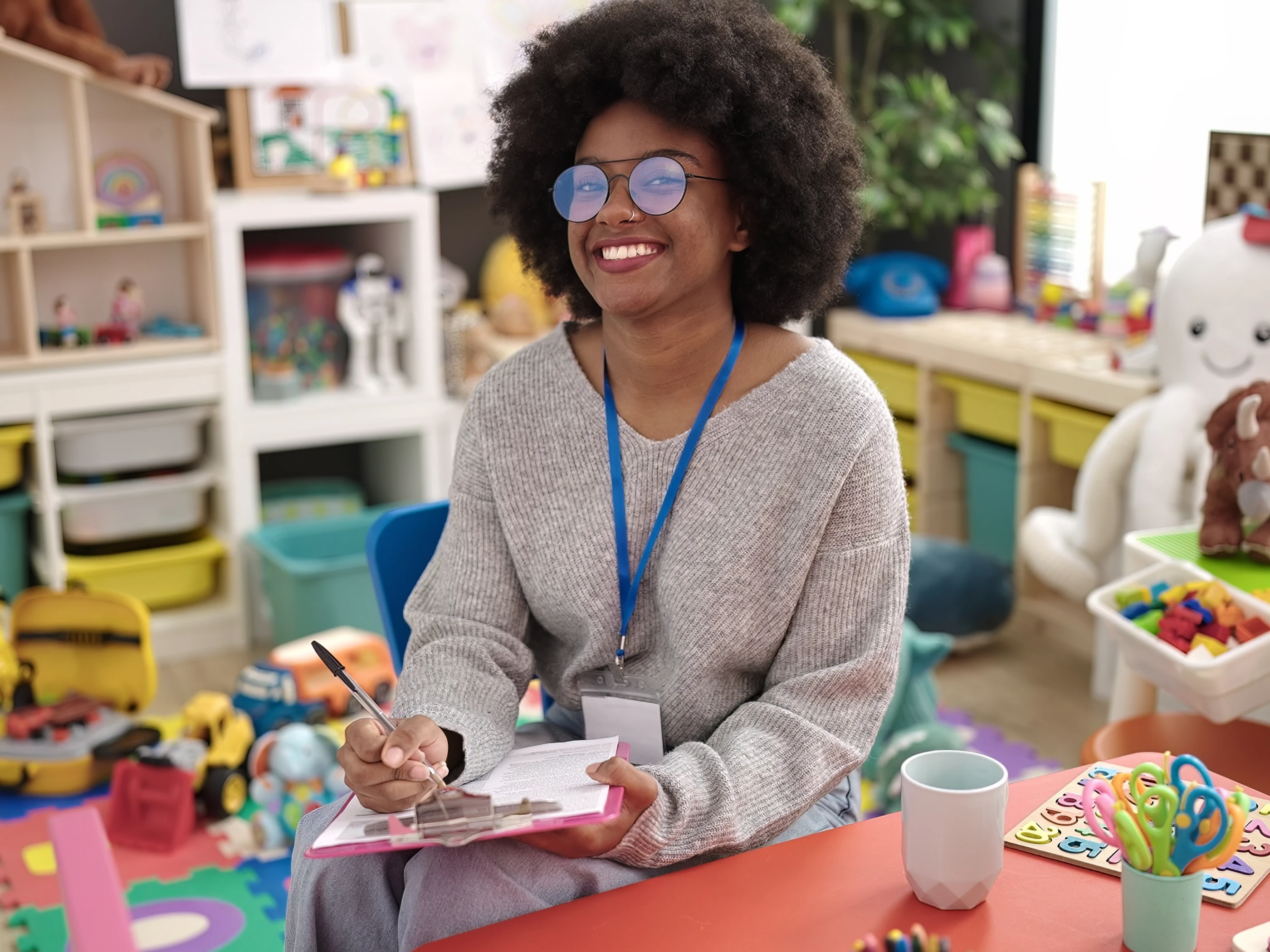 School teacher smiling in classroom.