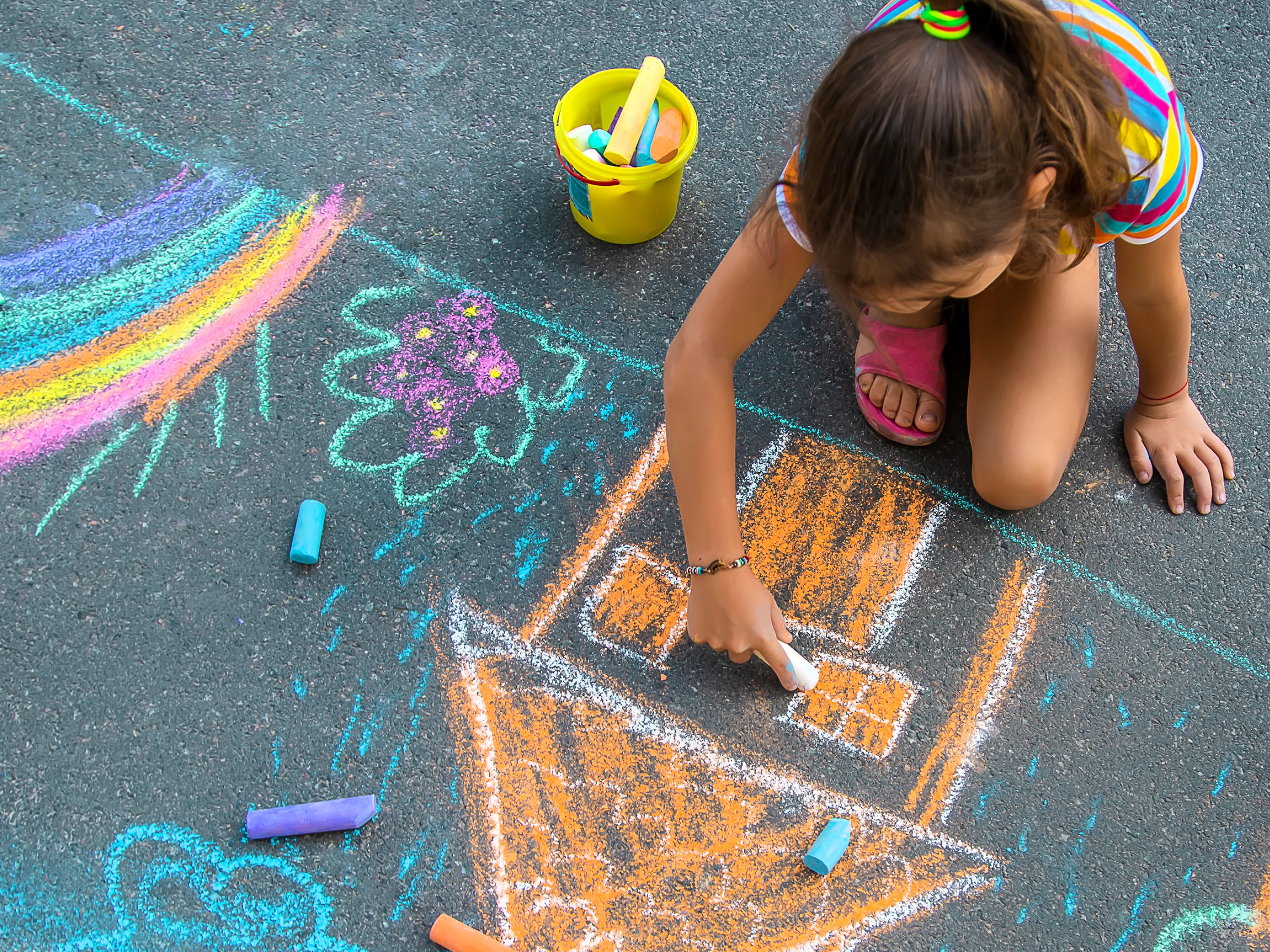 Child drawing with chalk