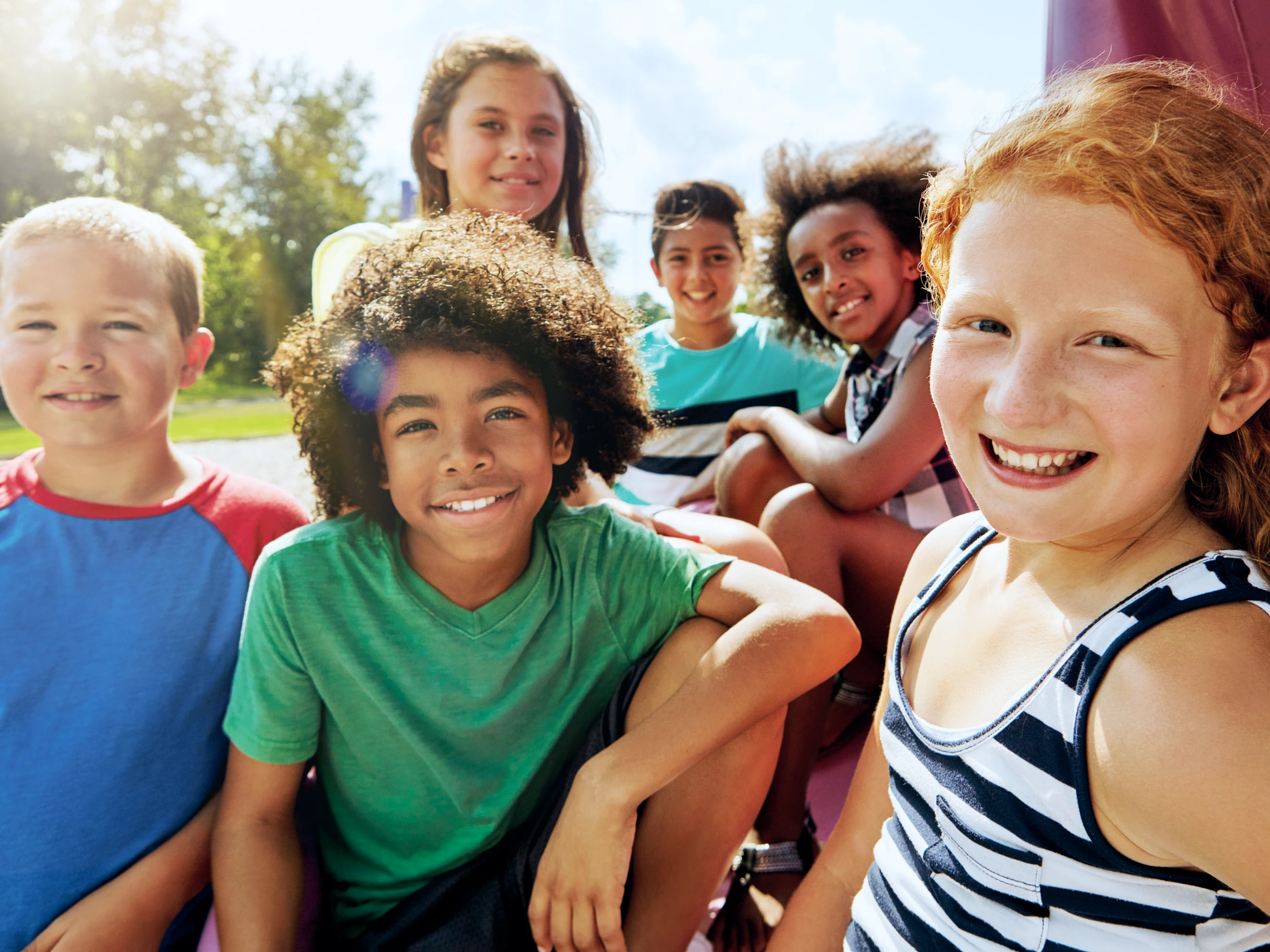 Smiling students on playground.