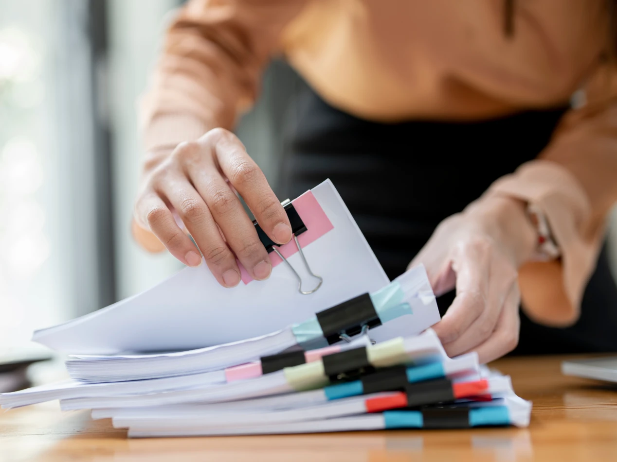 School administrator sorts through a stack of papers.