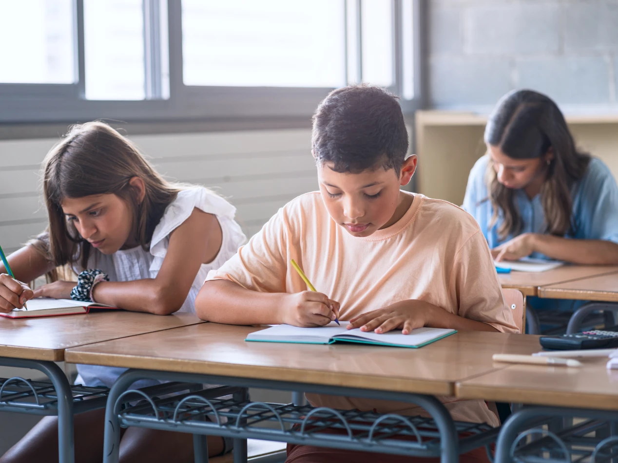 Students in classroom working at their desks.