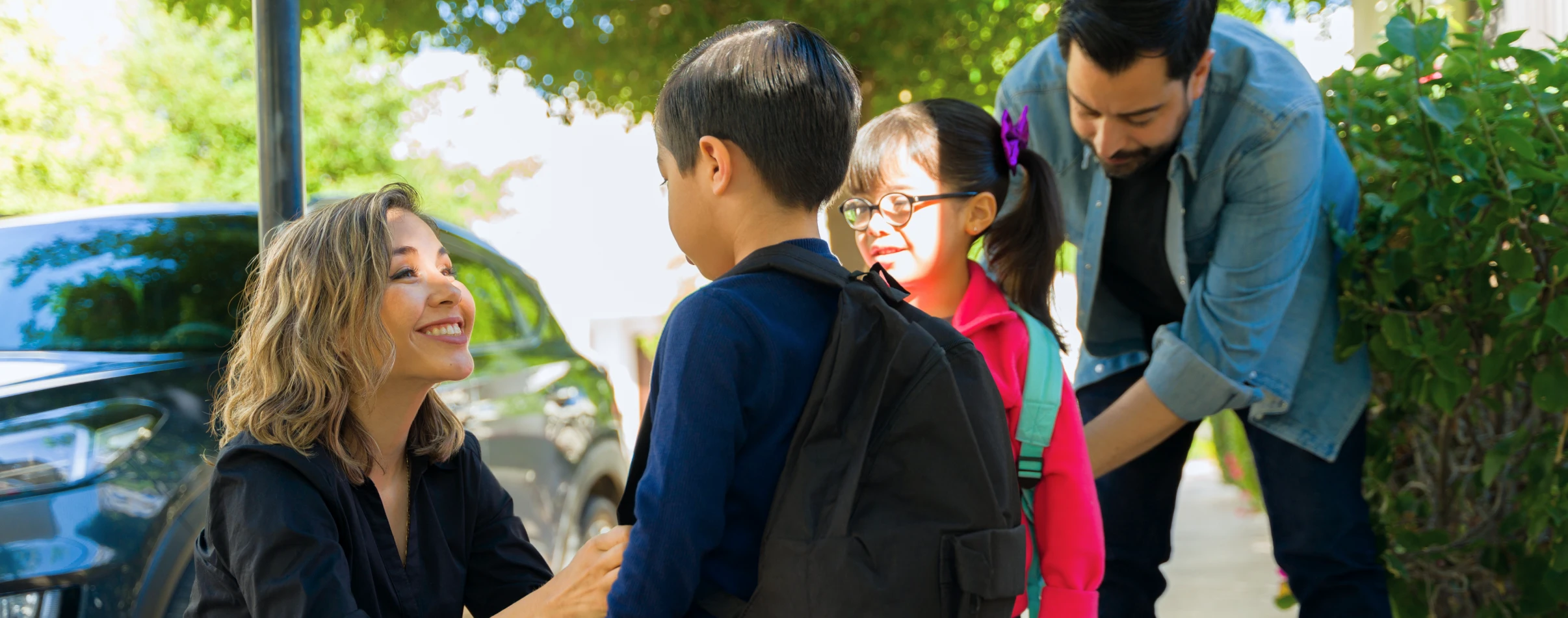 Family outside getting ready for school.